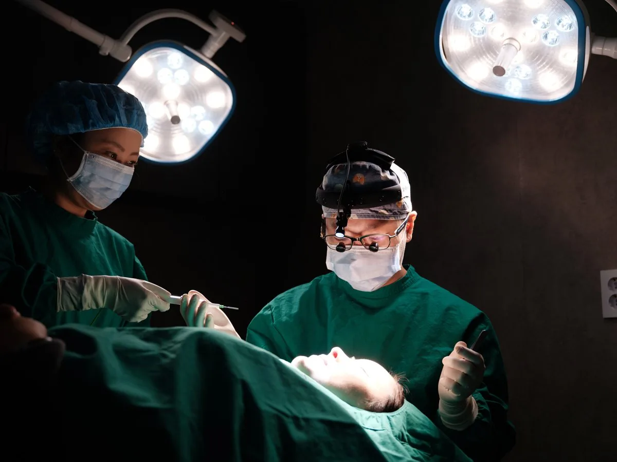 Ê-kíp phẫu thuật làm việc dưới đèn mổ tại Rewind Plastic Surgery