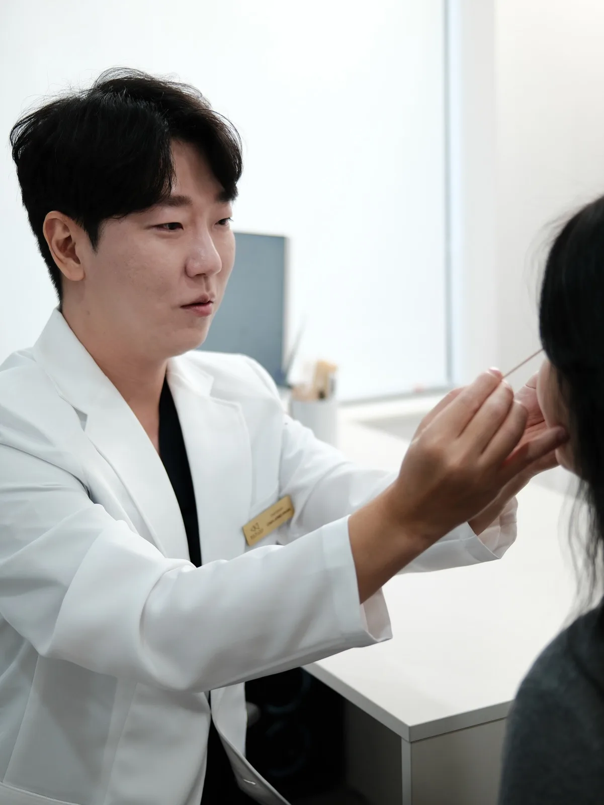 El Dr. Jonghwan Choi valorando la piel del rostro antes del tratamiento